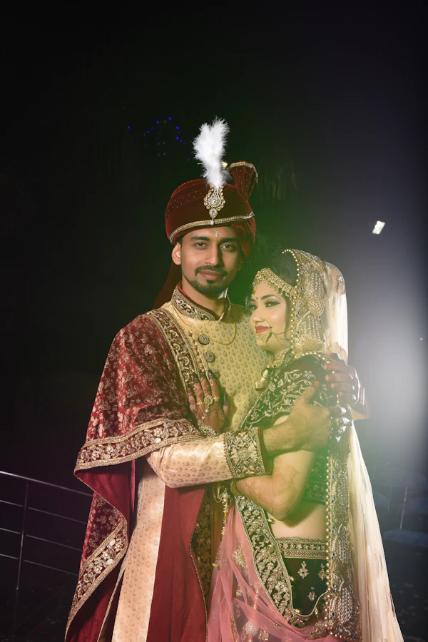 Newlywed couple embracing in traditional wedding attire